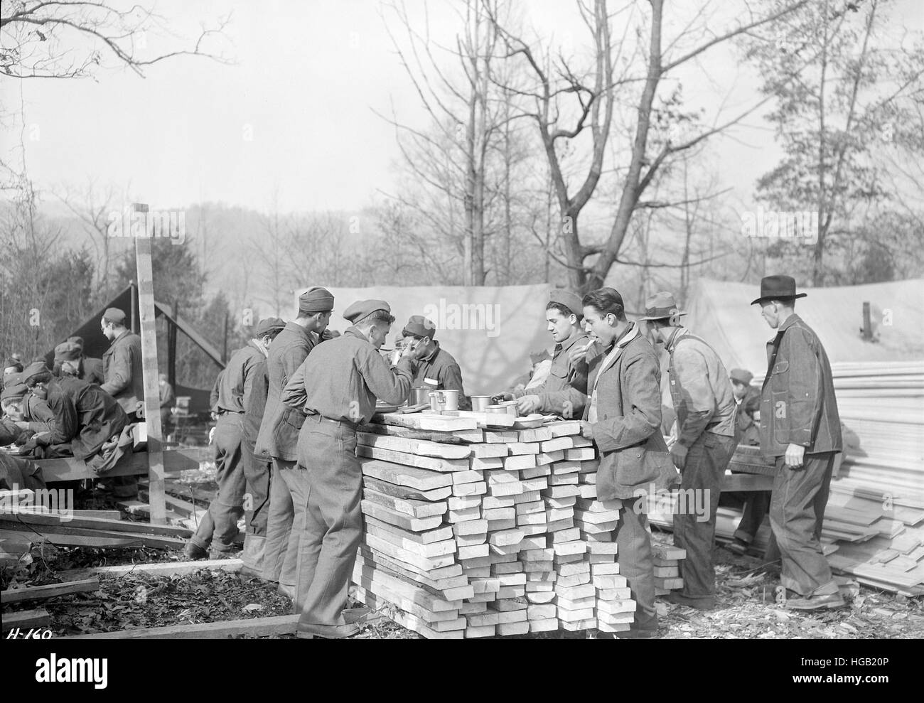 Men eating outdoors at a Civilian Conservation Corp camp in Tennessee, 1933. Stock Photo