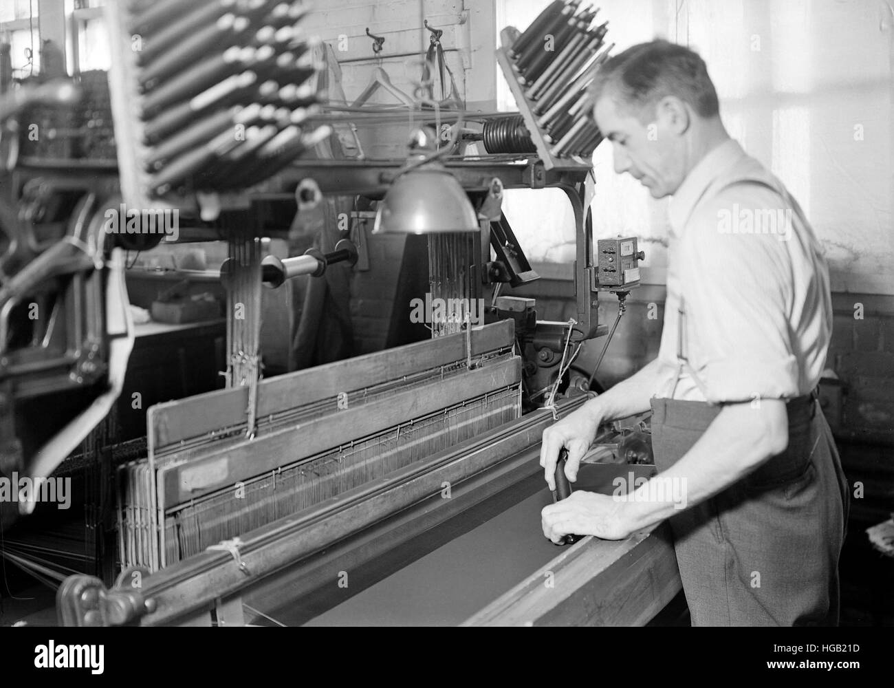 Man doubling and twisting silk, 1936. Stock Photo