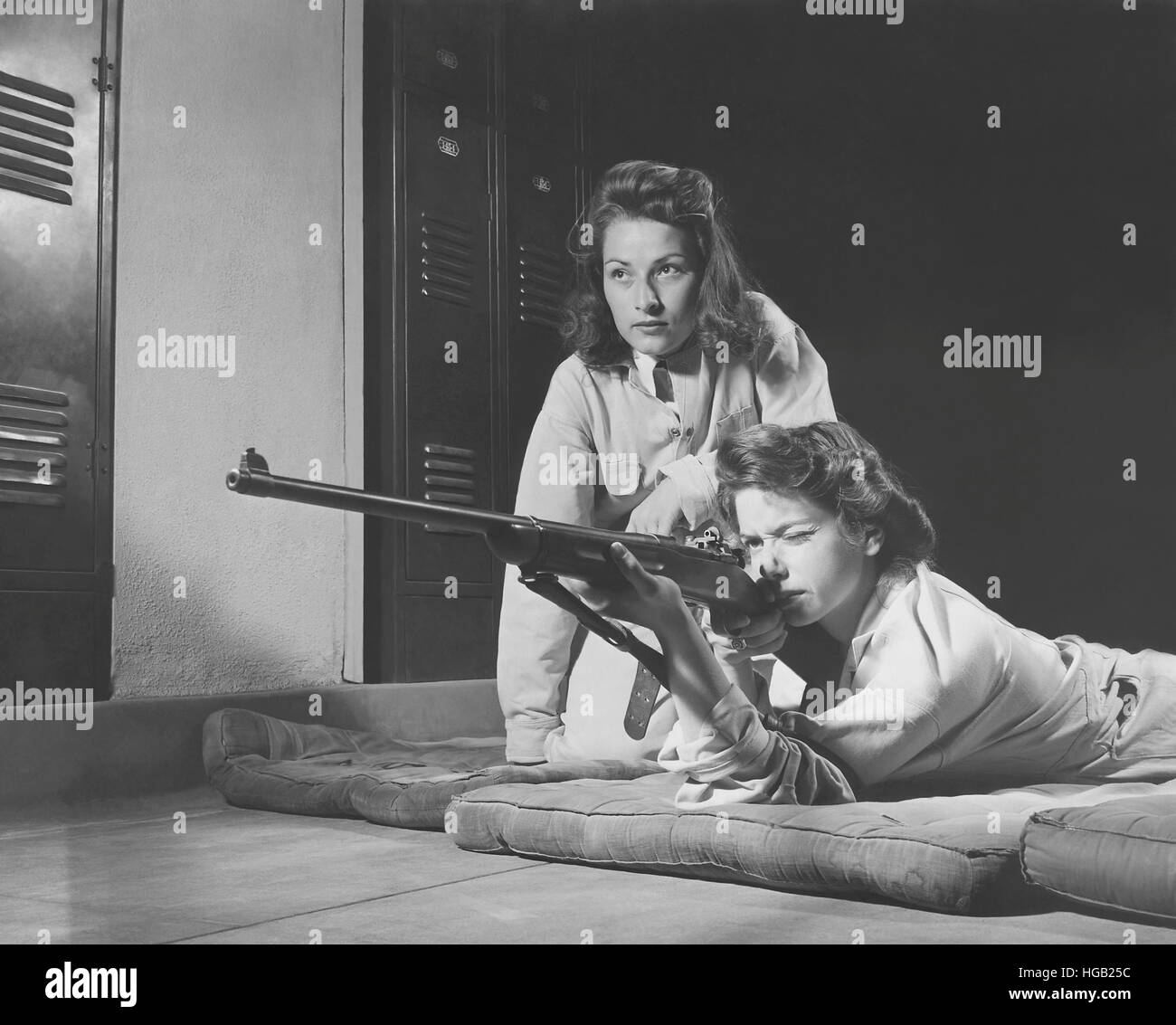 Girls practice marksmanship in high school hall. circa 1942 Stock Photo