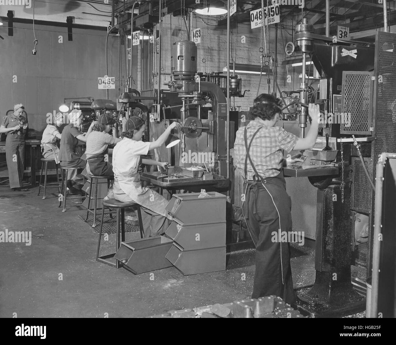 Women drill press operators working in a west coast airplane factory. circa 1942 Stock Photo