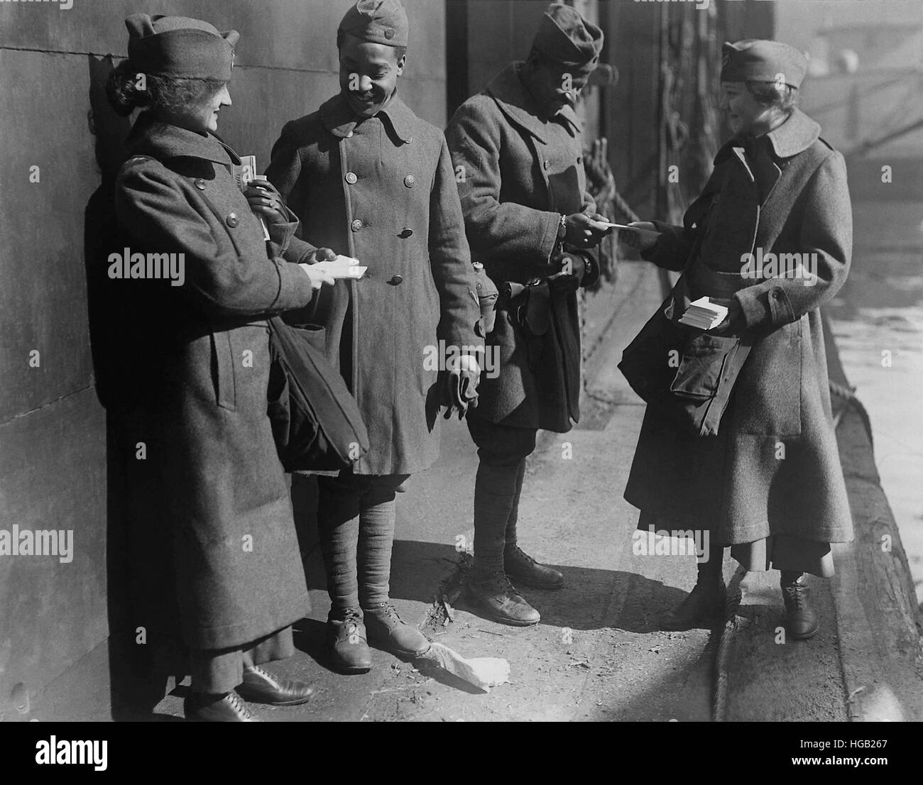 Salvation Army lassies giving sweets to African American soldiers. Stock Photo