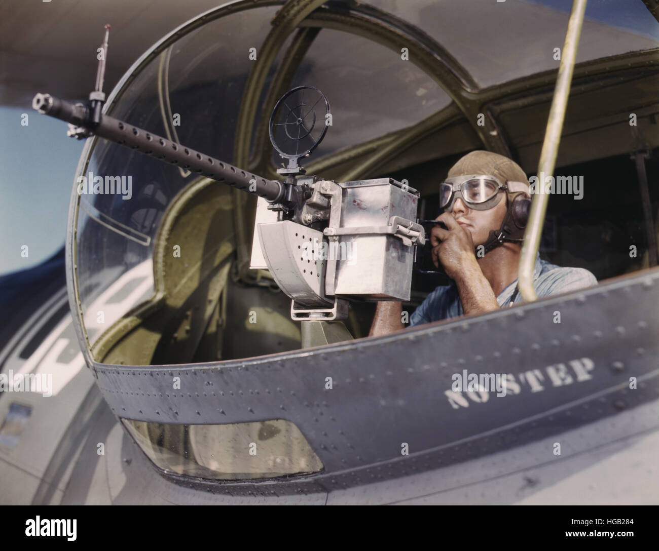 Aviation Ordnanceman tries out a 30-caliber machine gun on a Navy plane, 1942. Stock Photo