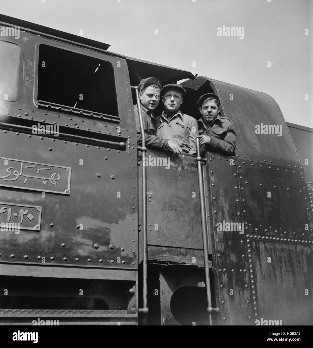 American, Russian and English engineers in the cab of an engine, 1943. Stock Photo