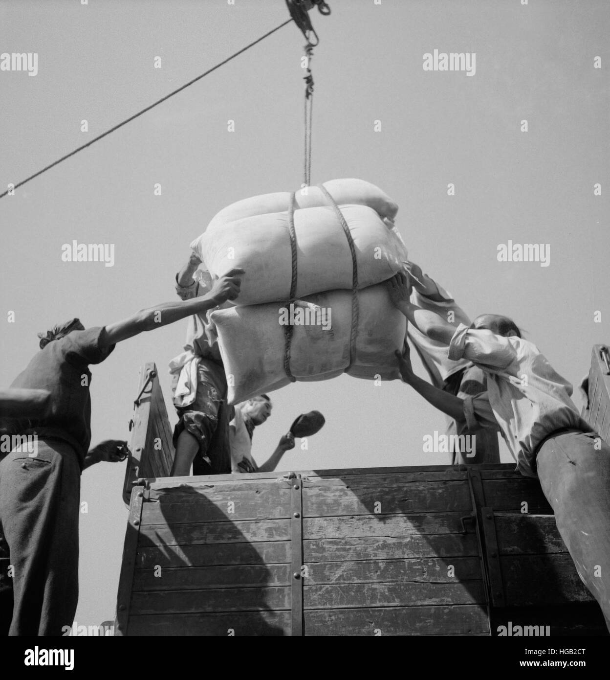 American white flour is loaded onto trucks to be delivered to people in Messina, Sicily, 1943. Stock Photo
