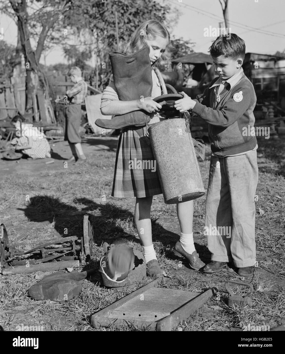 Young children collecting scrap for donation to their war industries, 1942. Stock Photo