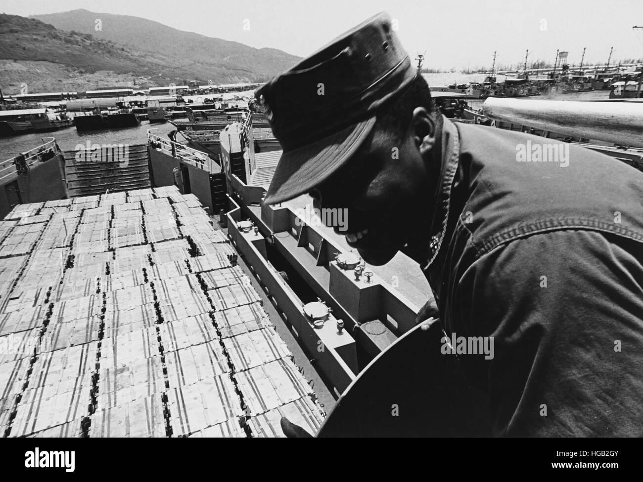 Chief Boatswain's Mate smiles as his crew prepares to leave South Vietnam on a cargo run, 1969. Stock Photo
