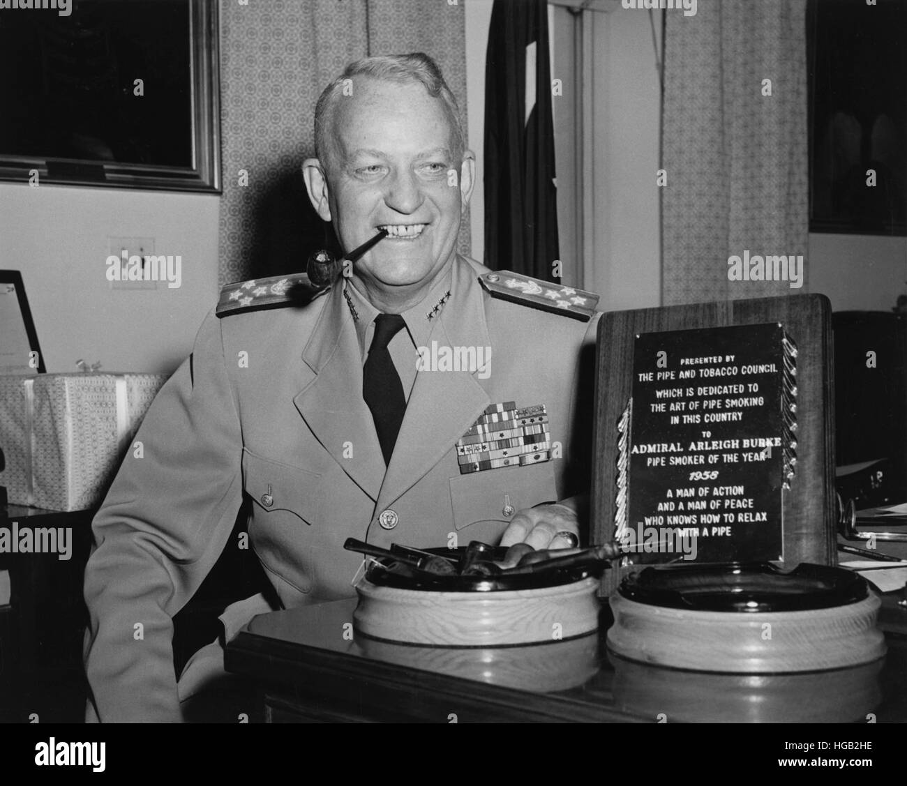 U.S. Navy Admiral Arleigh A. Burke smoking a tobacco pipe, 1958. Stock Photo