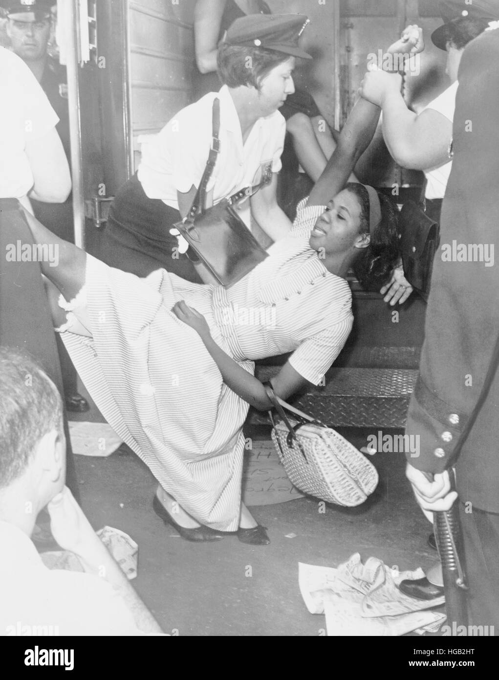 African American woman being carried to police patrol wagon, Brooklyn, New York, 1963. Stock Photo