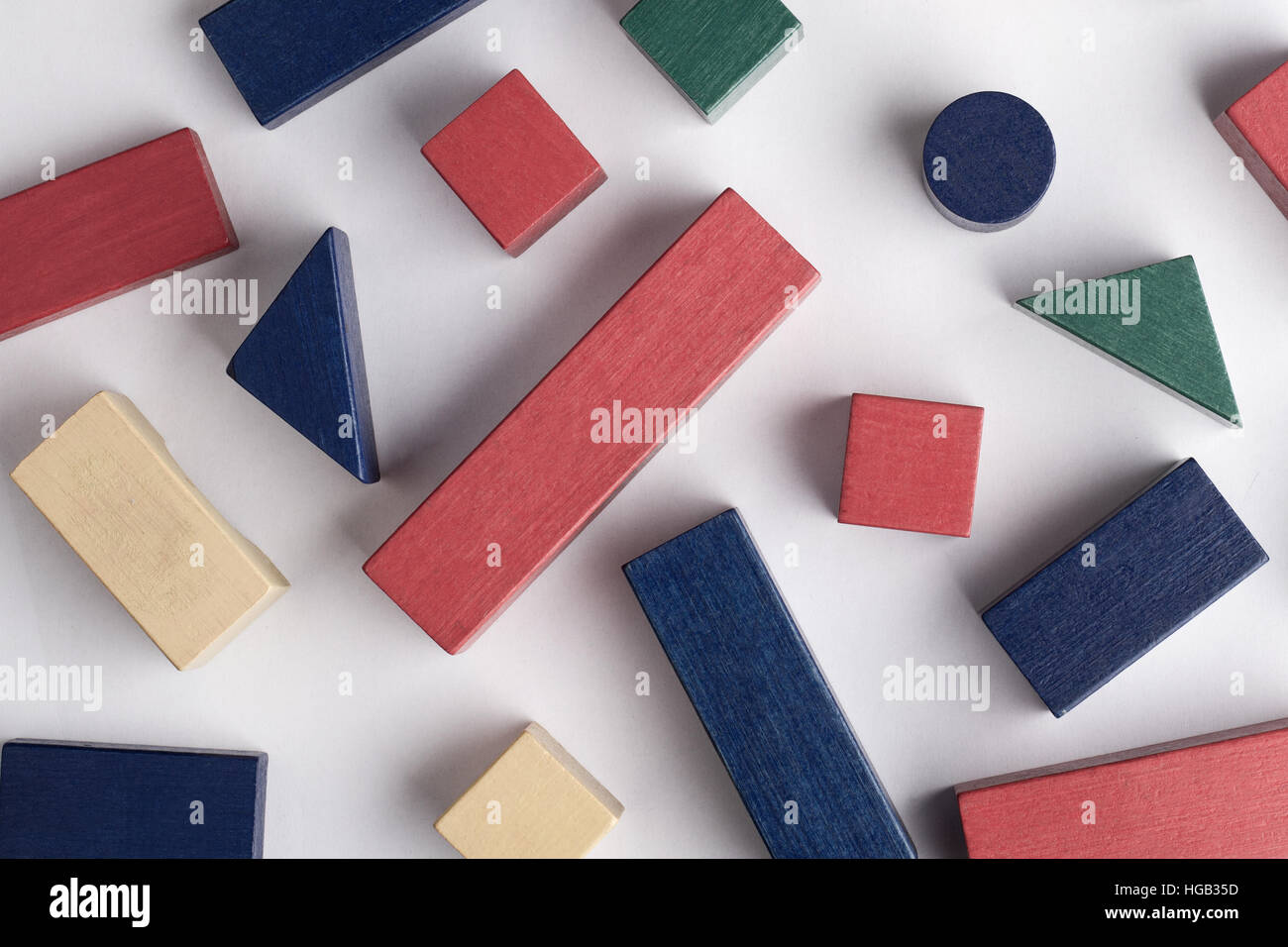 abstract composition with colored toy building blocks of many shapes on white background Stock Photo