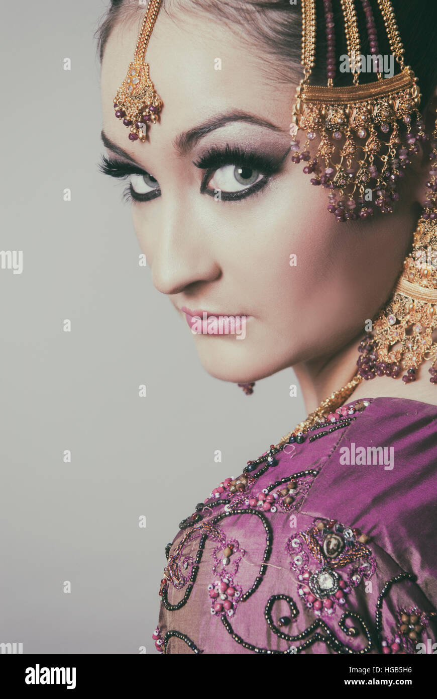 Serious Asian bride looking over shoulder Stock Photo
