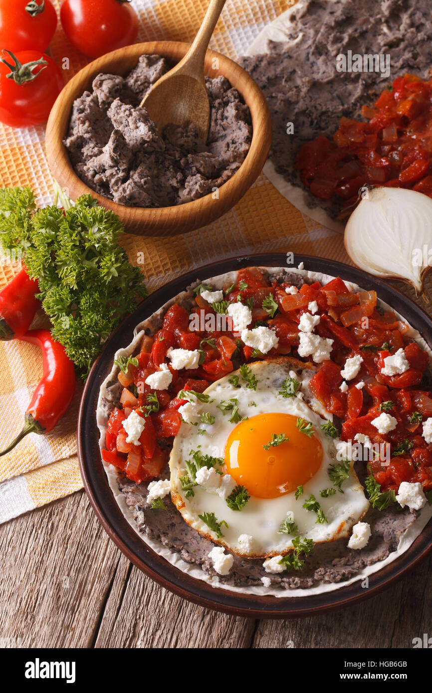 Mexican food: huevos rancheros close-up on a plate on the table. vertical Stock Photo