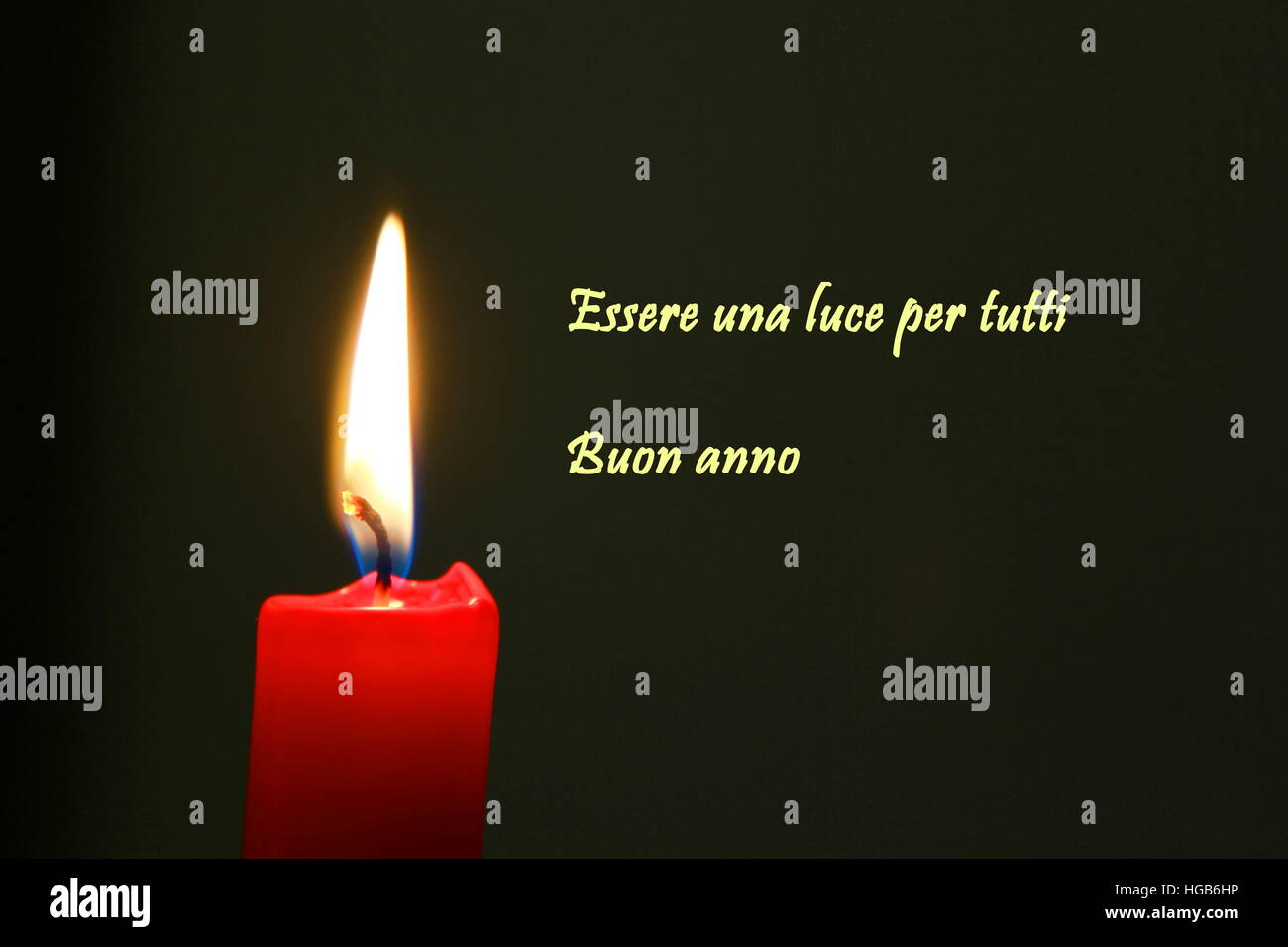 Red candle with flame on black background with italian text Stock Photo