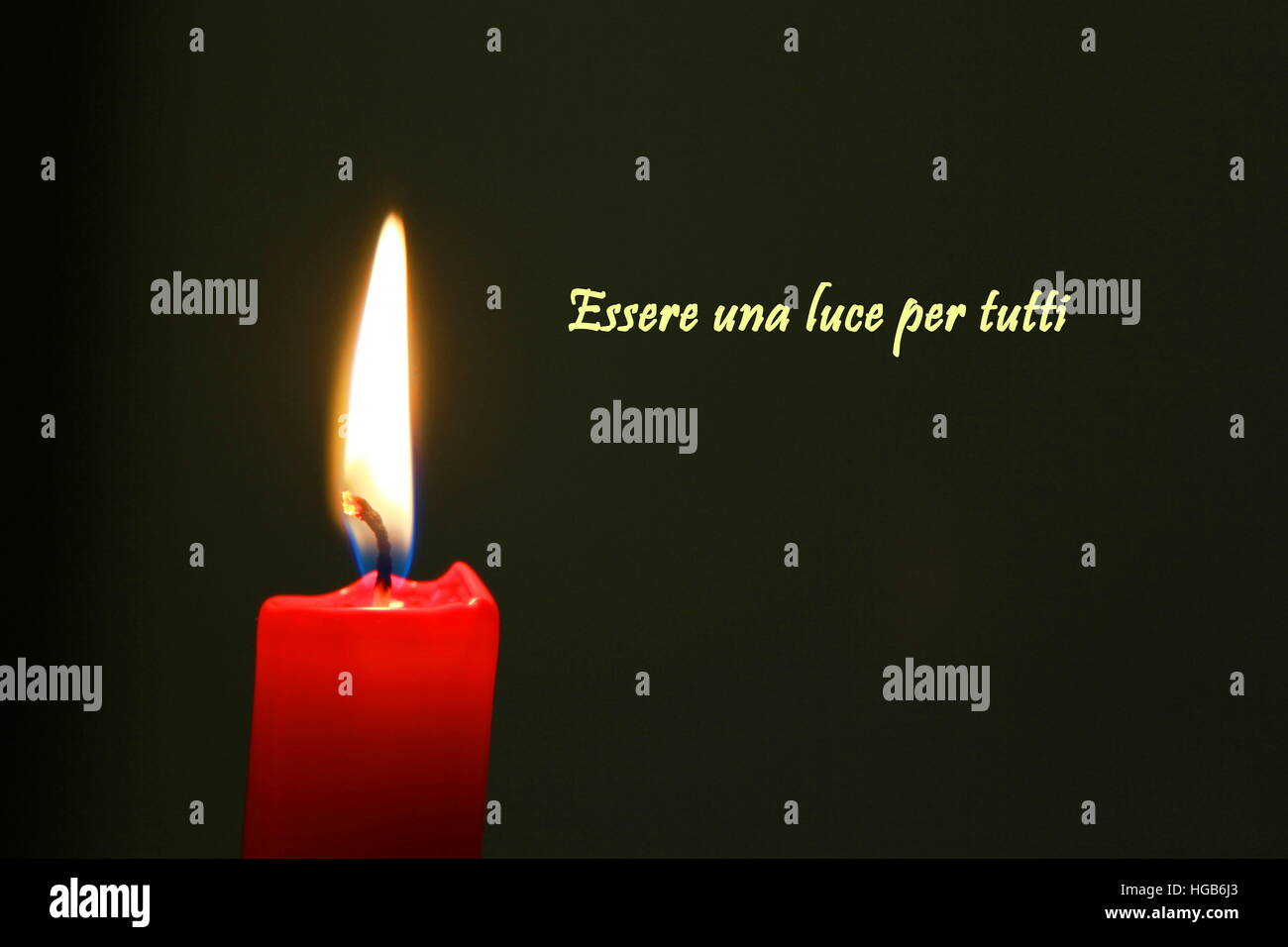 Red candle with flame on black background with italian text Stock Photo