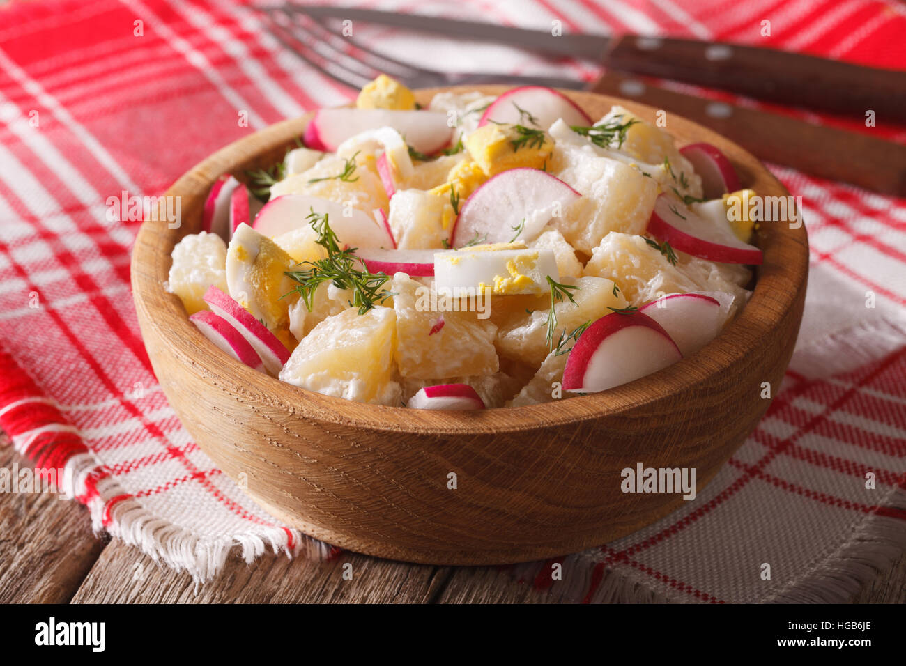 potato salad with radish and mayonnaise in a bowl close-up on the table. horizontal Stock Photo