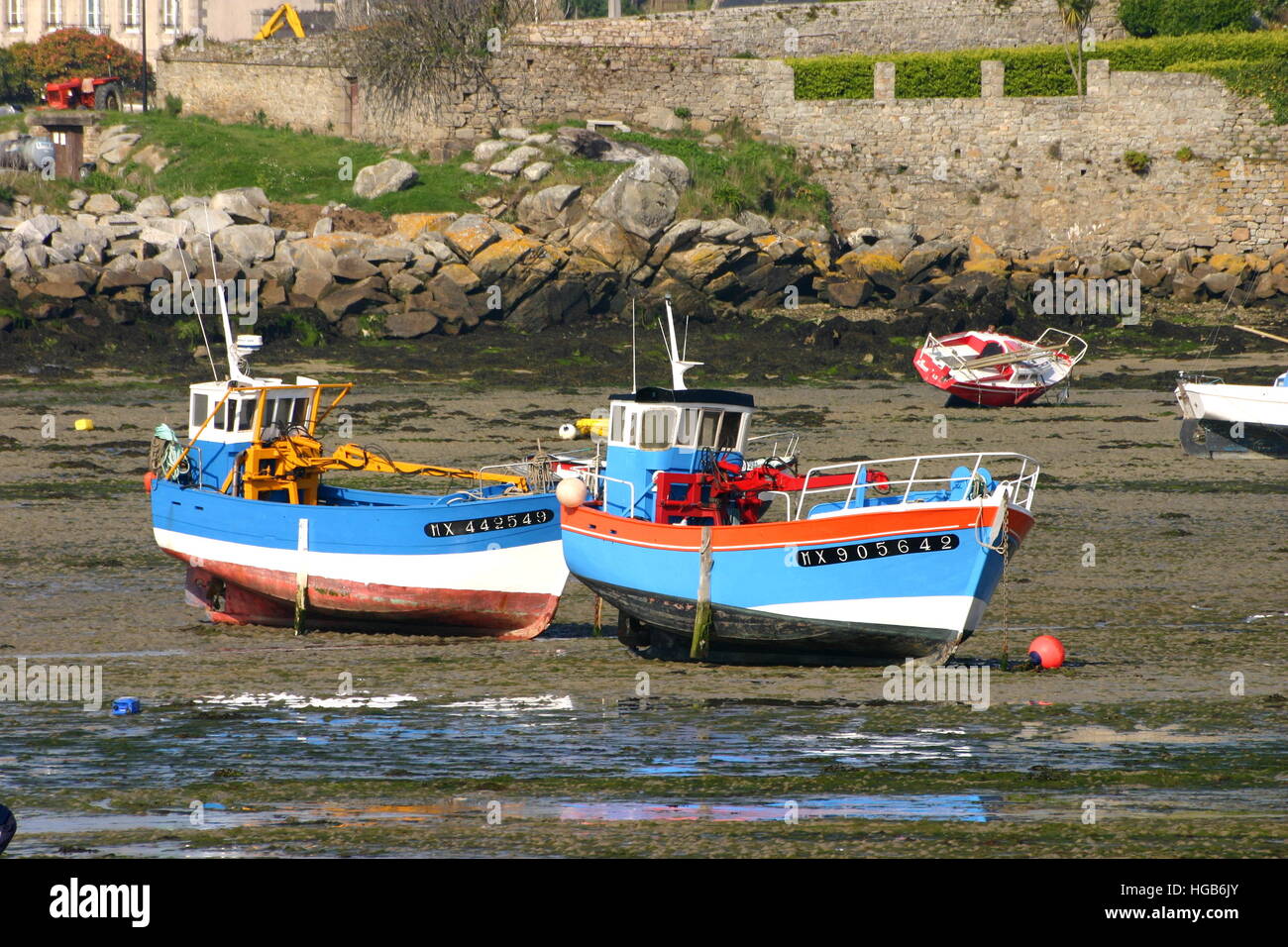 Two fishing boats on ground during ebb at french coast Stock Photo