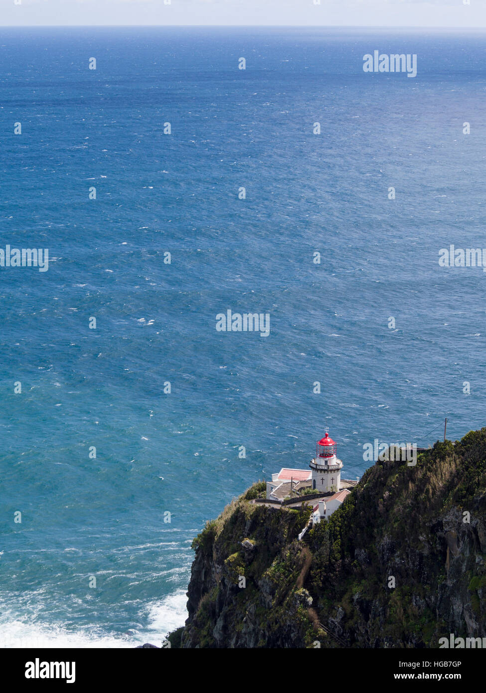 Farol do Arnel presides over the open Atlantic. This old lighthouse just South of Nordeste, sits on a prominatory high above a pounding Atlantic ocean Stock Photo