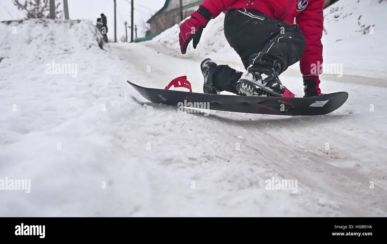 boy snowboarding fell in the snow with holidays winter sport Stock