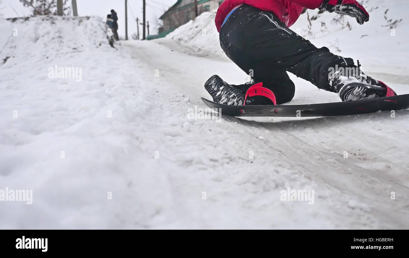 boy snowboarding fell in the snow with holidays winter sport Stock