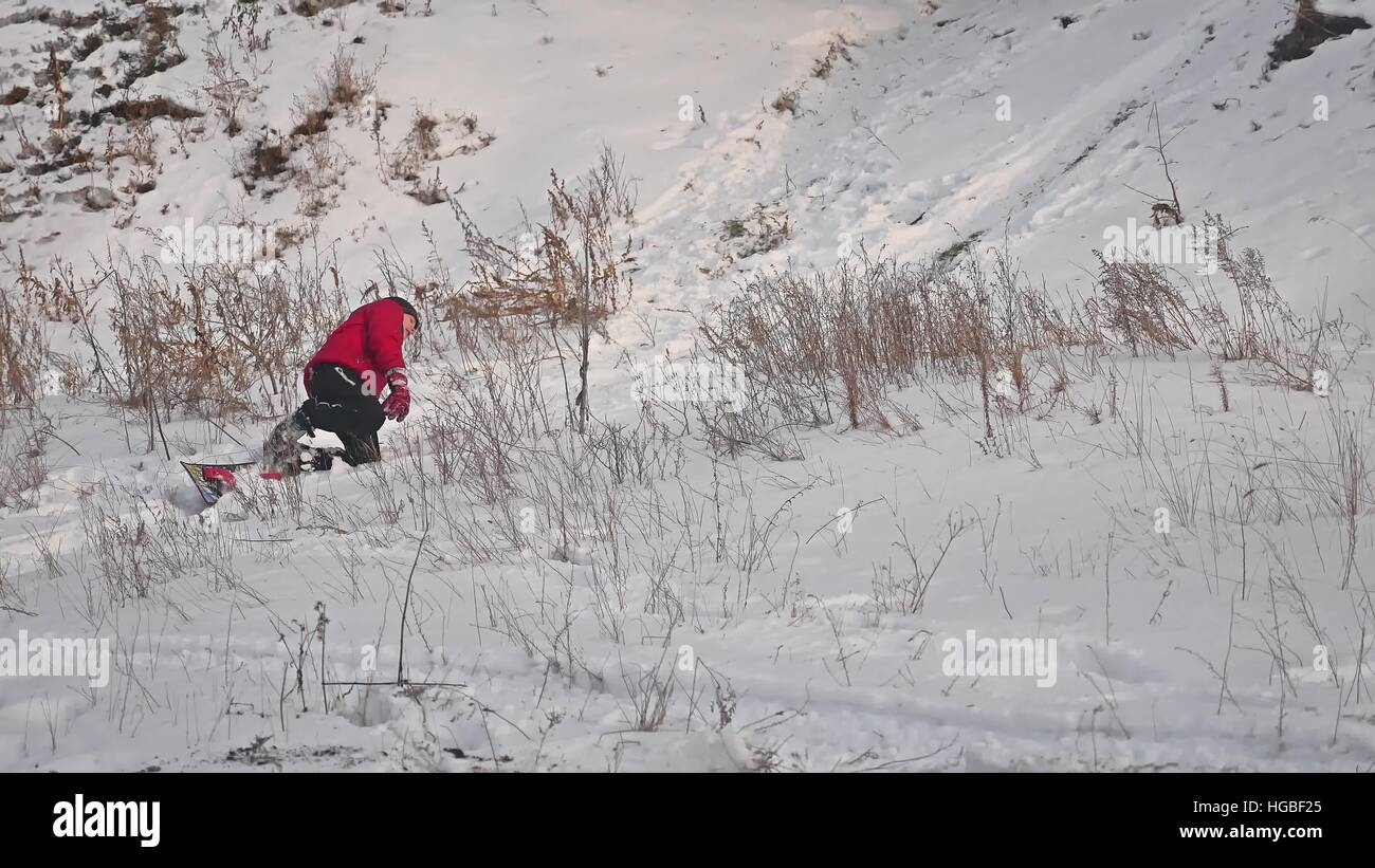 boy man snowboarding fall rolling in the snow with sport holidays ...