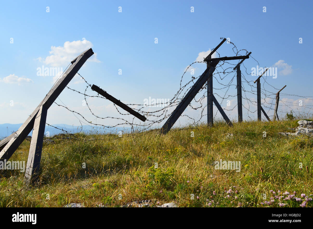 Silhouette of old barbwired borderline high on the mountain height Stock Photo