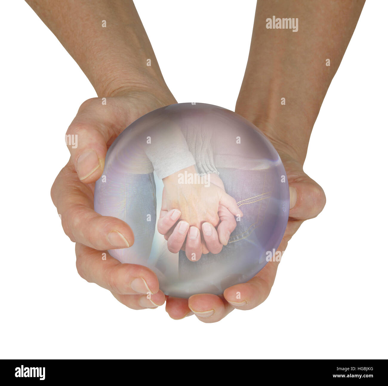 female fortune teller with large crystal ball held in cupped hands with a vision of a couple holding hands within, on white Stock Photo