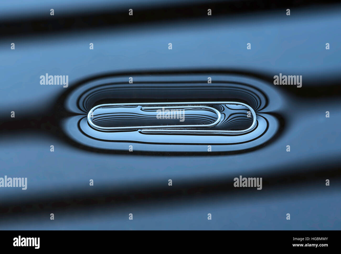 Floating Paperclip. Paper clip floating on water courtesy of surface