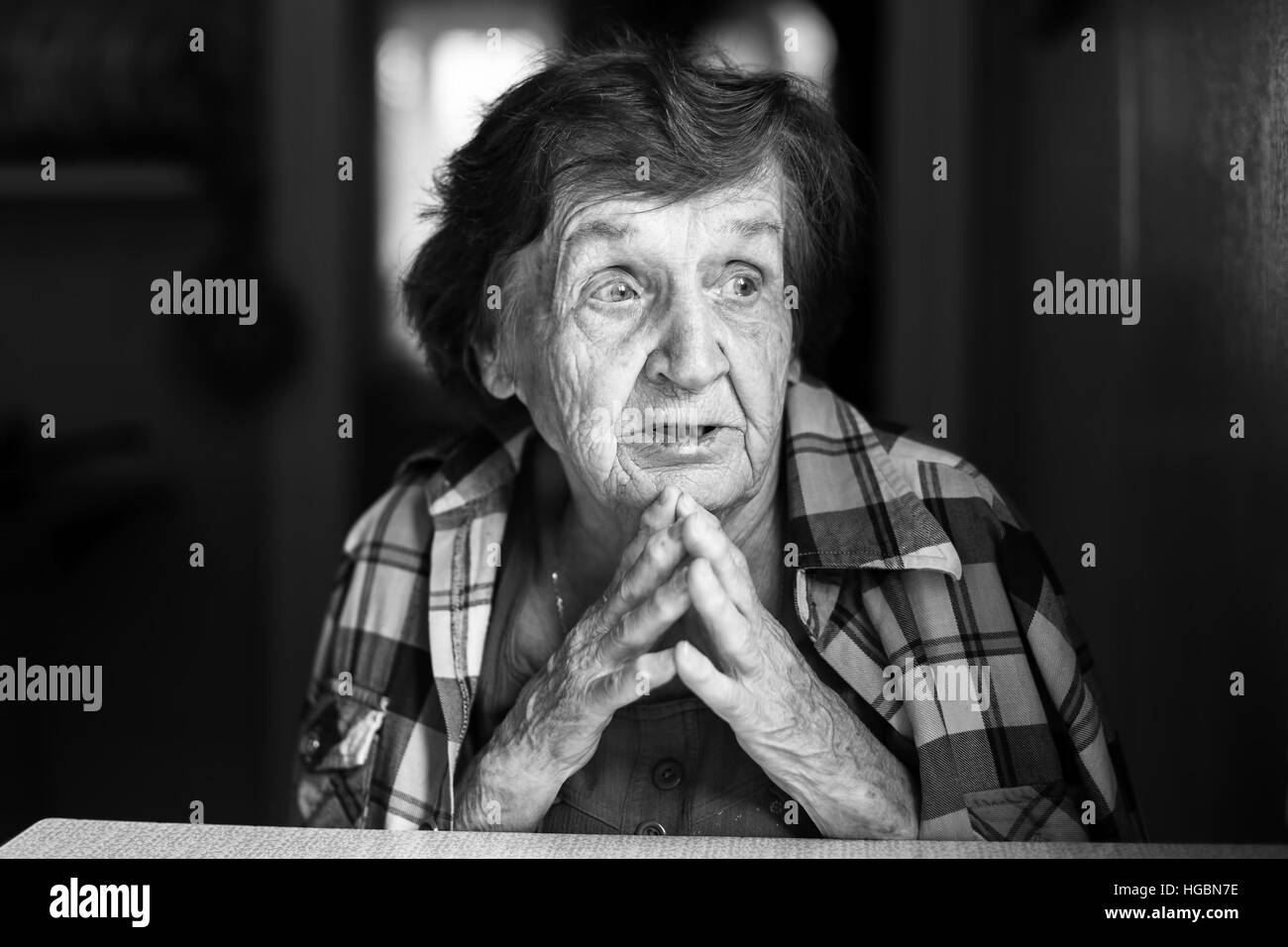 Emotional elderly woman black and white portrait. Stock Photo