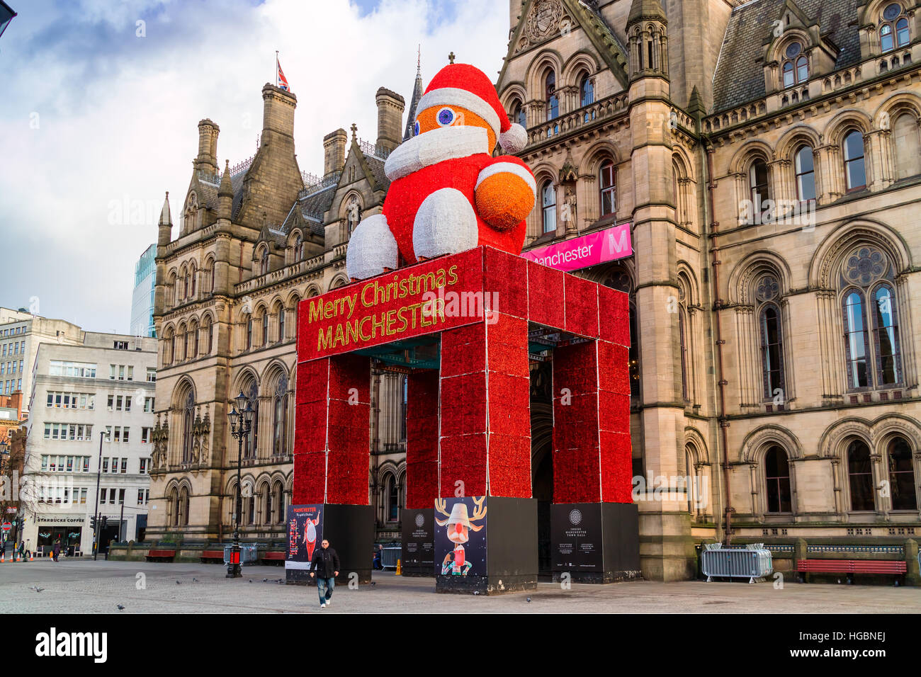 Historic Manchester Town Hall in Albert Square decorated for festive season with a large figure of Father Christmas. Stock Photo