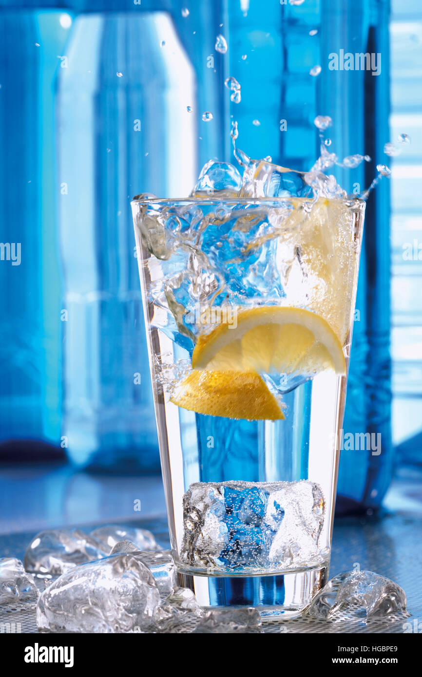 lemon-slices-falling-into-a-glass-of-water-stock-photo-alamy