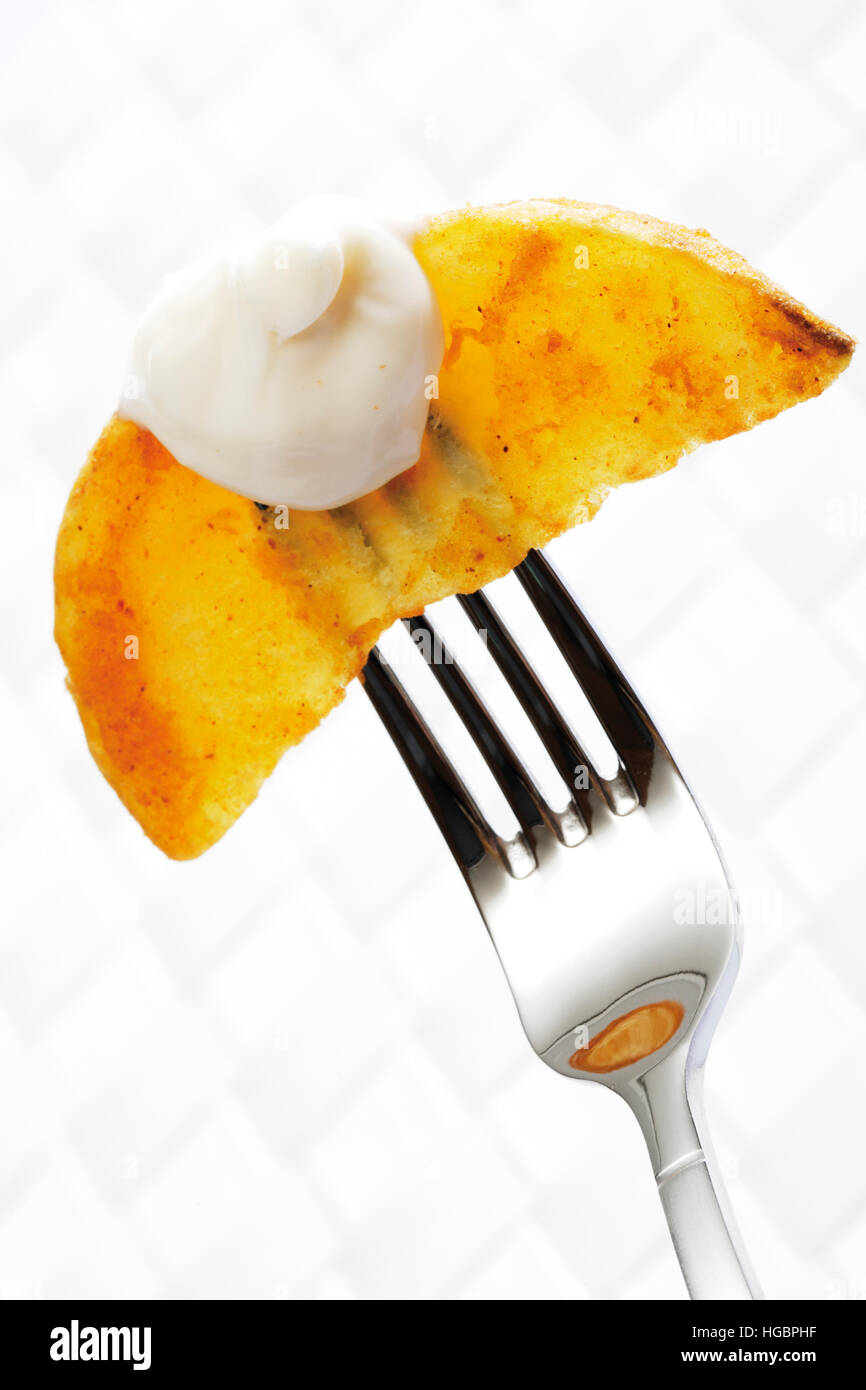 Potato wedge with mayonnaise on a fork Stock Photo Alamy
