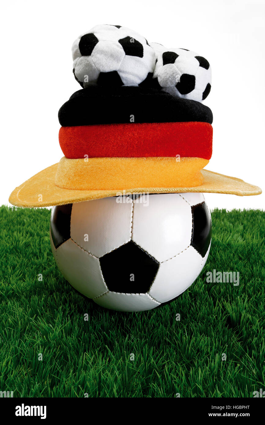 Football with Germany fan hat laying on grass Stock Photo