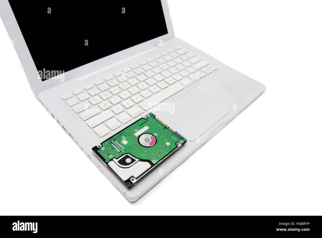 Laptop computer with an exposed internal harddrive. White background. Stock Photo
