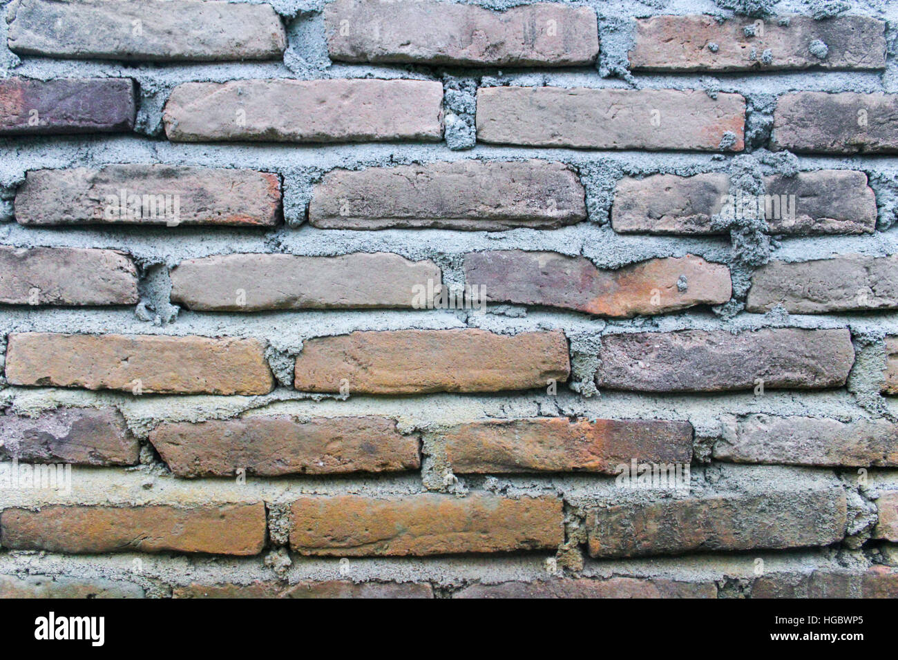 A brick wall and lot of cement Stock Photo