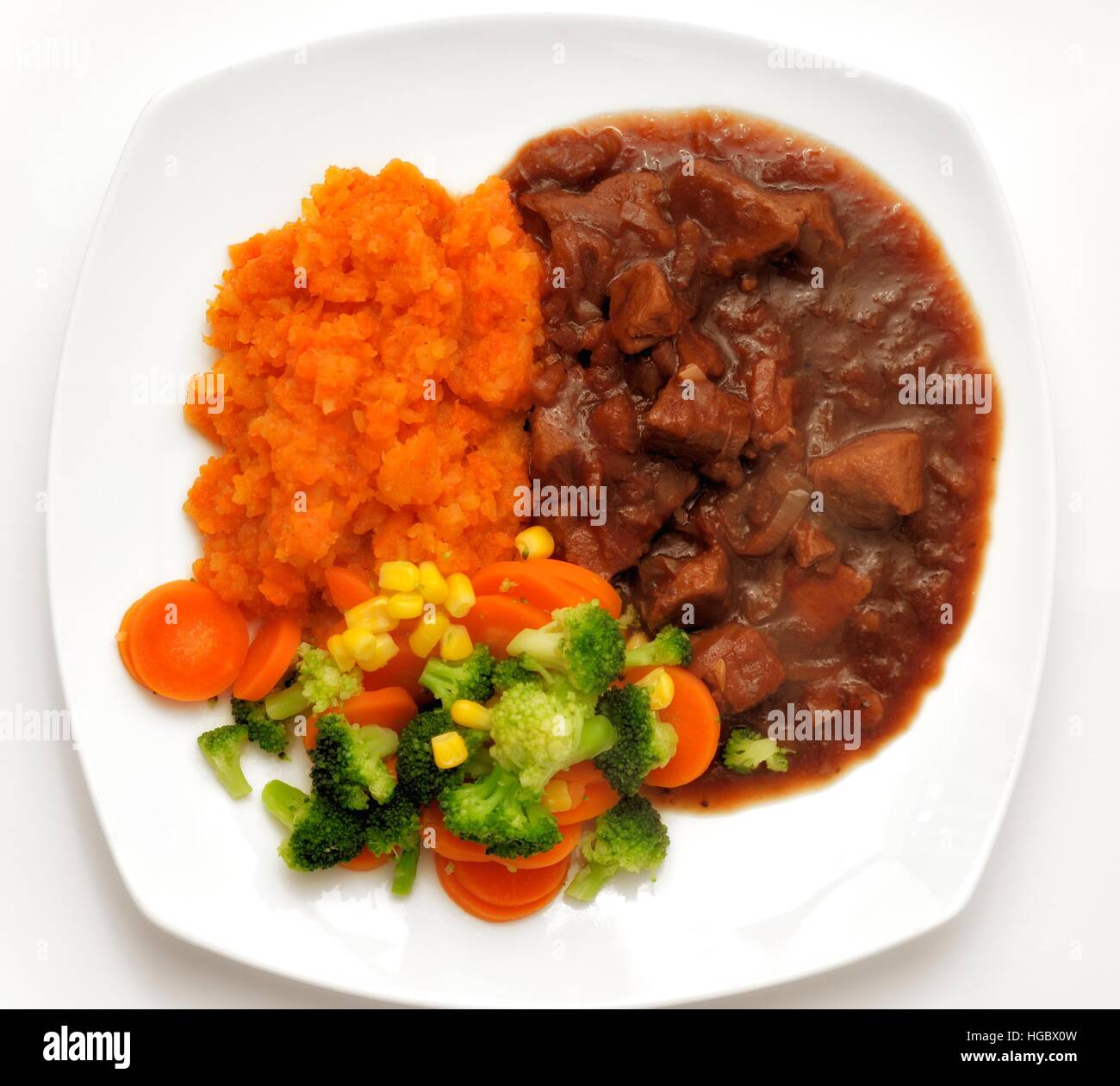 Chunks of beef in gravy with a selection of vegetables and a veg crush Stock Photo