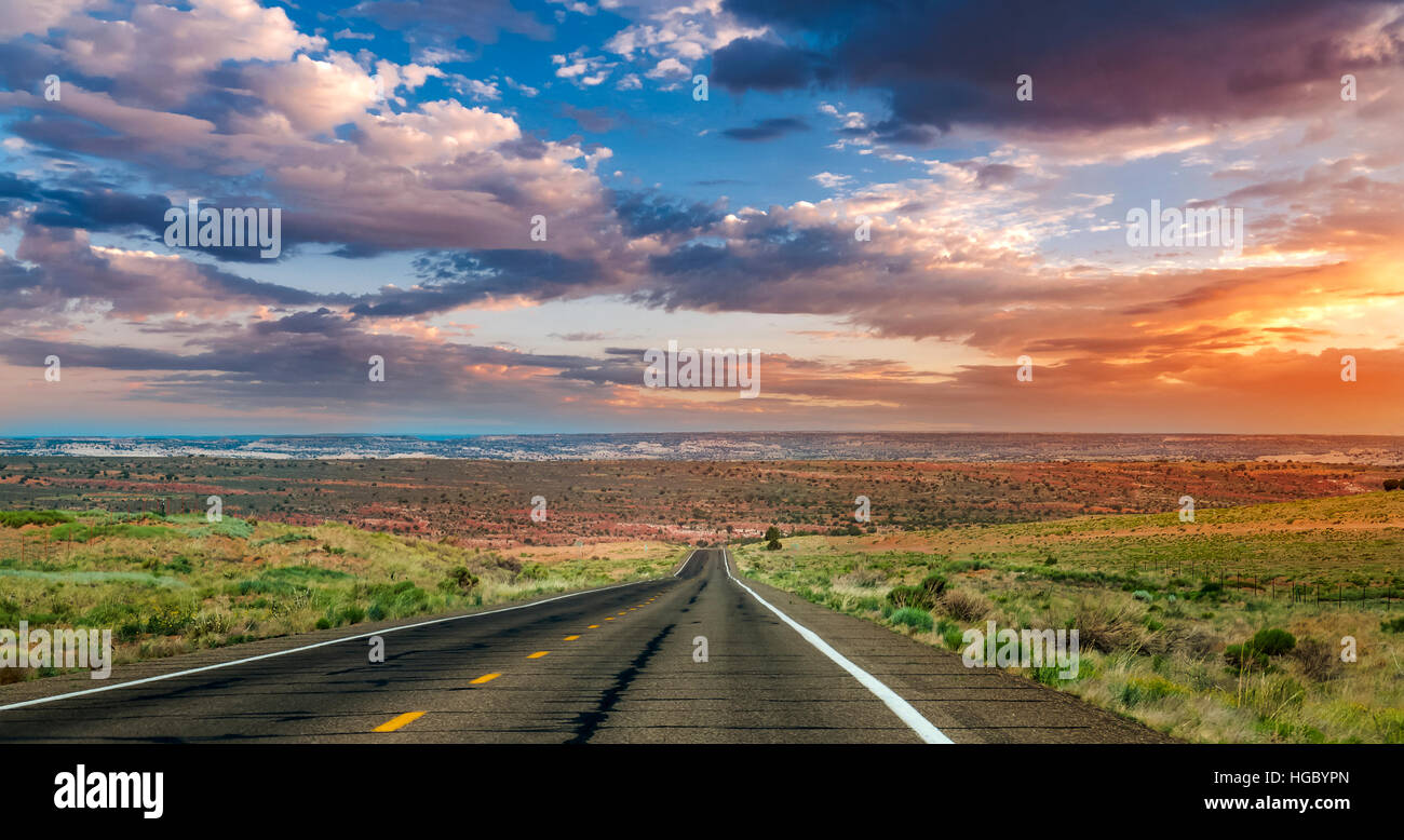 Straight road into the sunset in Arizona Stock Photo