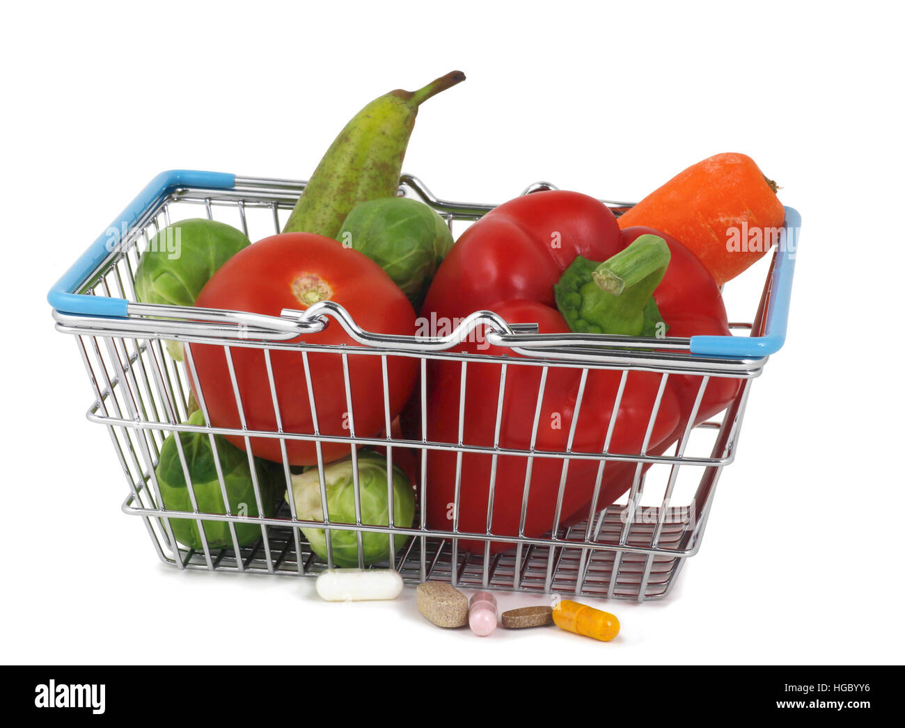 Shop for healthy food and supplements - a small shopping basket containing healthy fresh fruit and vegetables and five different health supplements Stock Photo