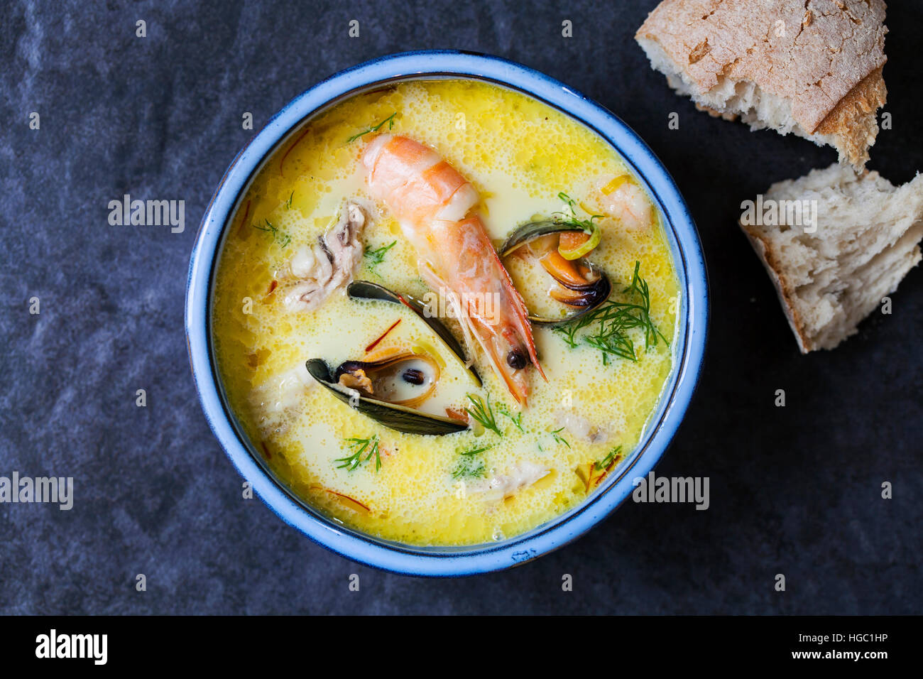 Scandinavian creamy fish soup with halibut, prawns and mussels Stock