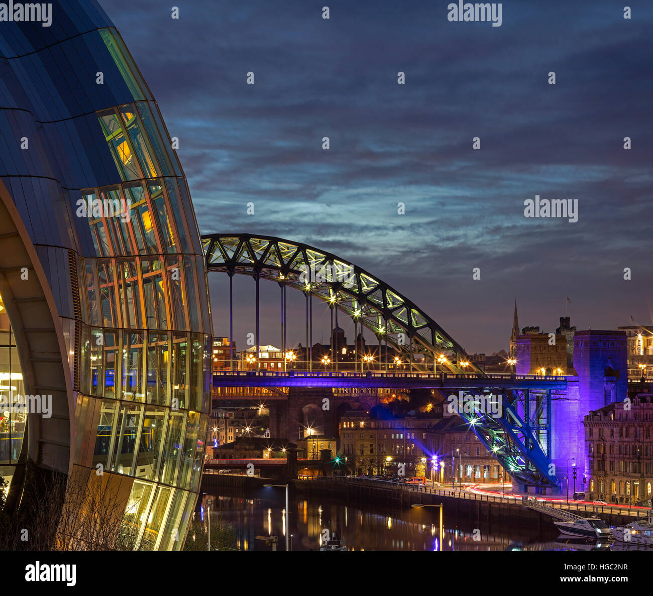 A dusk view of the Sage Gateshead on Gateshead Quays looking towards the Tyne Bridge Stock Photo