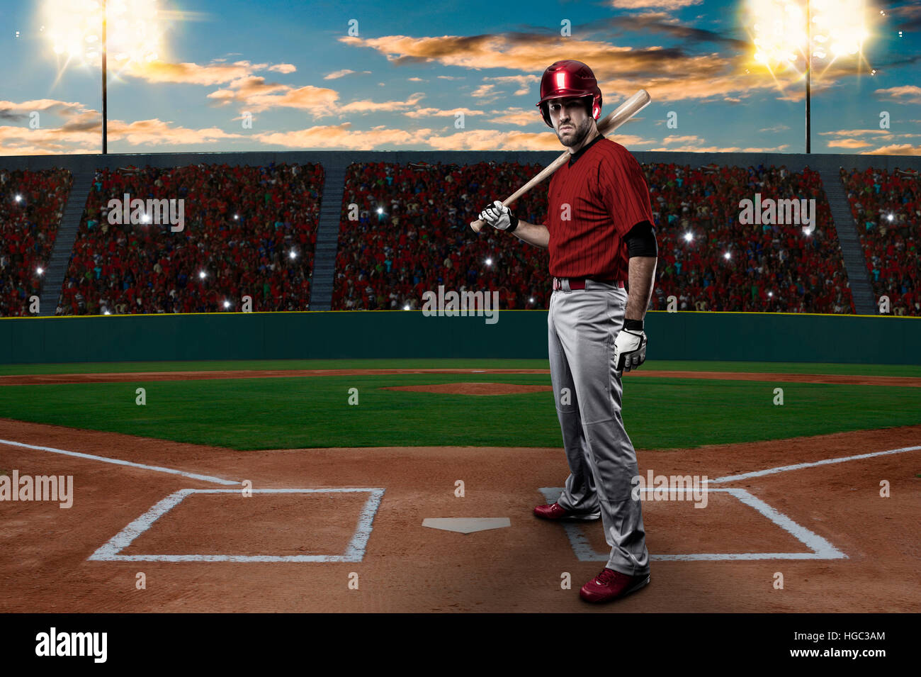 Baseball Player with a red uniform on baseball Stadium. Stock Photo