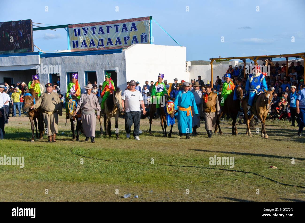 The winners of horse racing are in line for trophy. Stock Photo