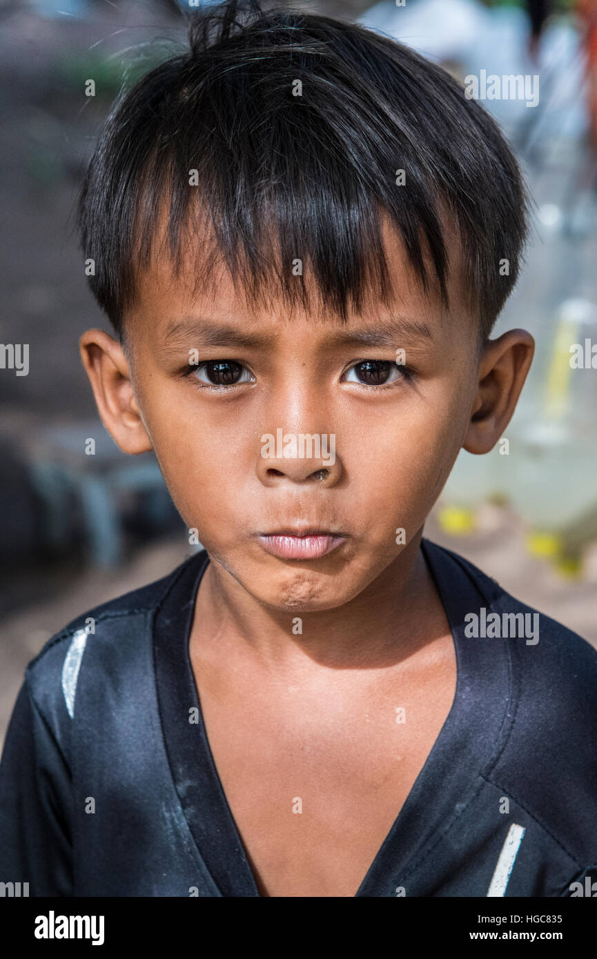Cambodian rural life near Siem Reap and the ancient city of Angkor Young boy not amused Stock Photo