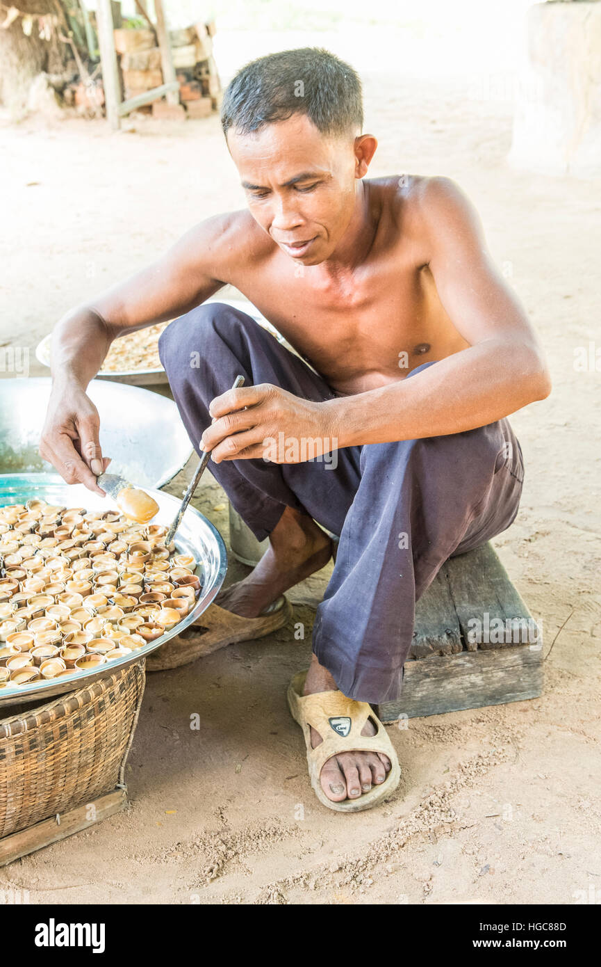 Cambodian rural life near Siem Reap and the ancient city of Angkor Market vendor making palm sugar sweets Stock Photo