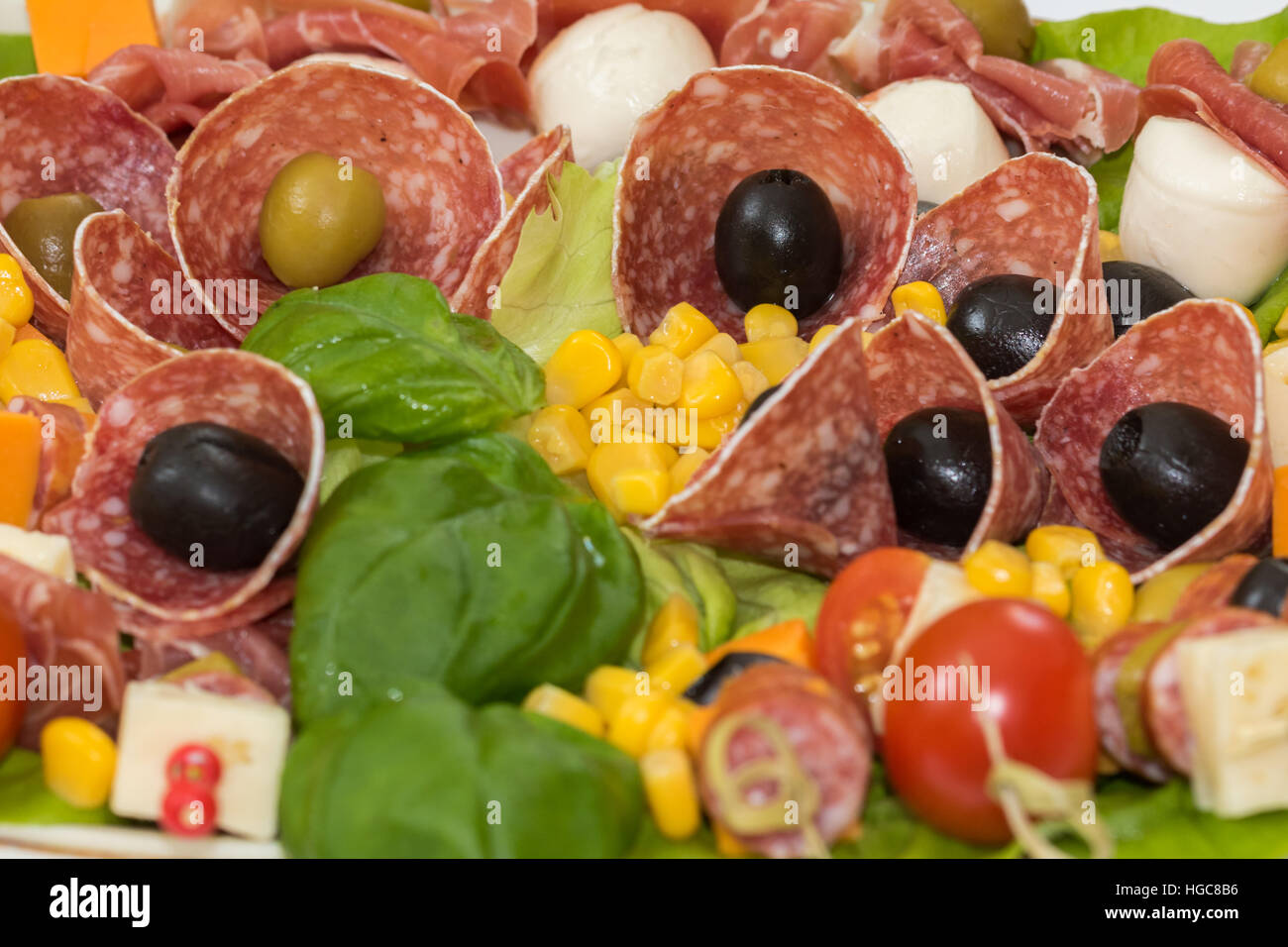 Appetizer platter with salami, olives, tomatoes,corn, cheese Stock