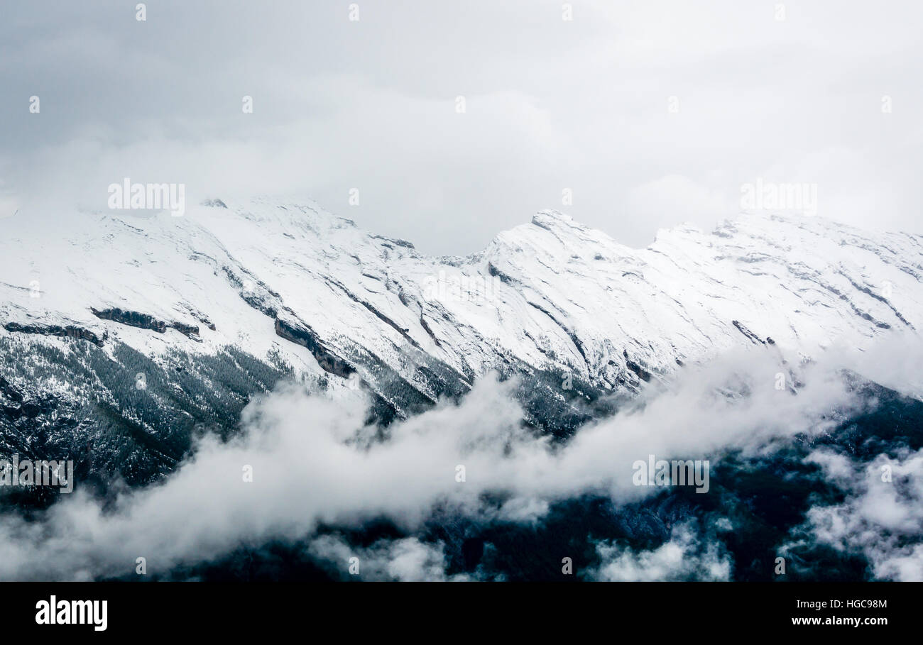 Cloud On Ridges A mountain ridge hidden by clouds and snow Stock Photo - Alamy