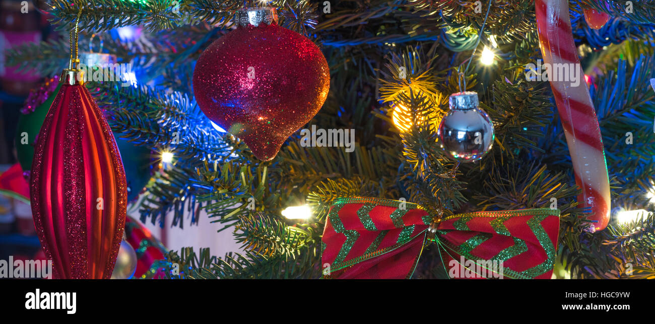 Christmas Tree Decorations Glowing Red Holiday Ornaments Hanging From Branches On A Small Faux Indoor Christmas Tree Decorations Glowing Red Holiday Ornaments Hanging From Branches On A Small Faux Indoor