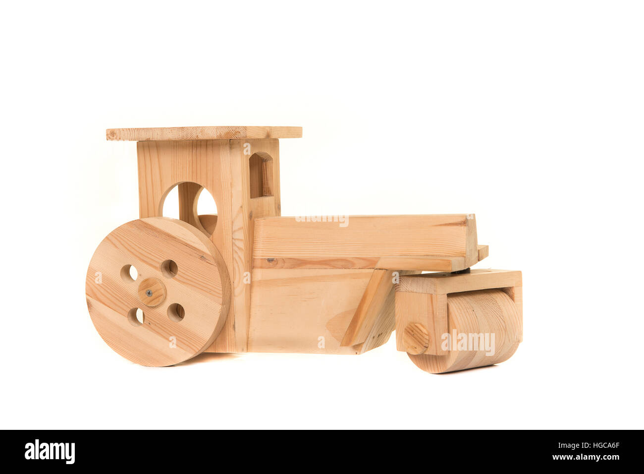 Wooden made toy tractor isolated on a white background Stock Photo