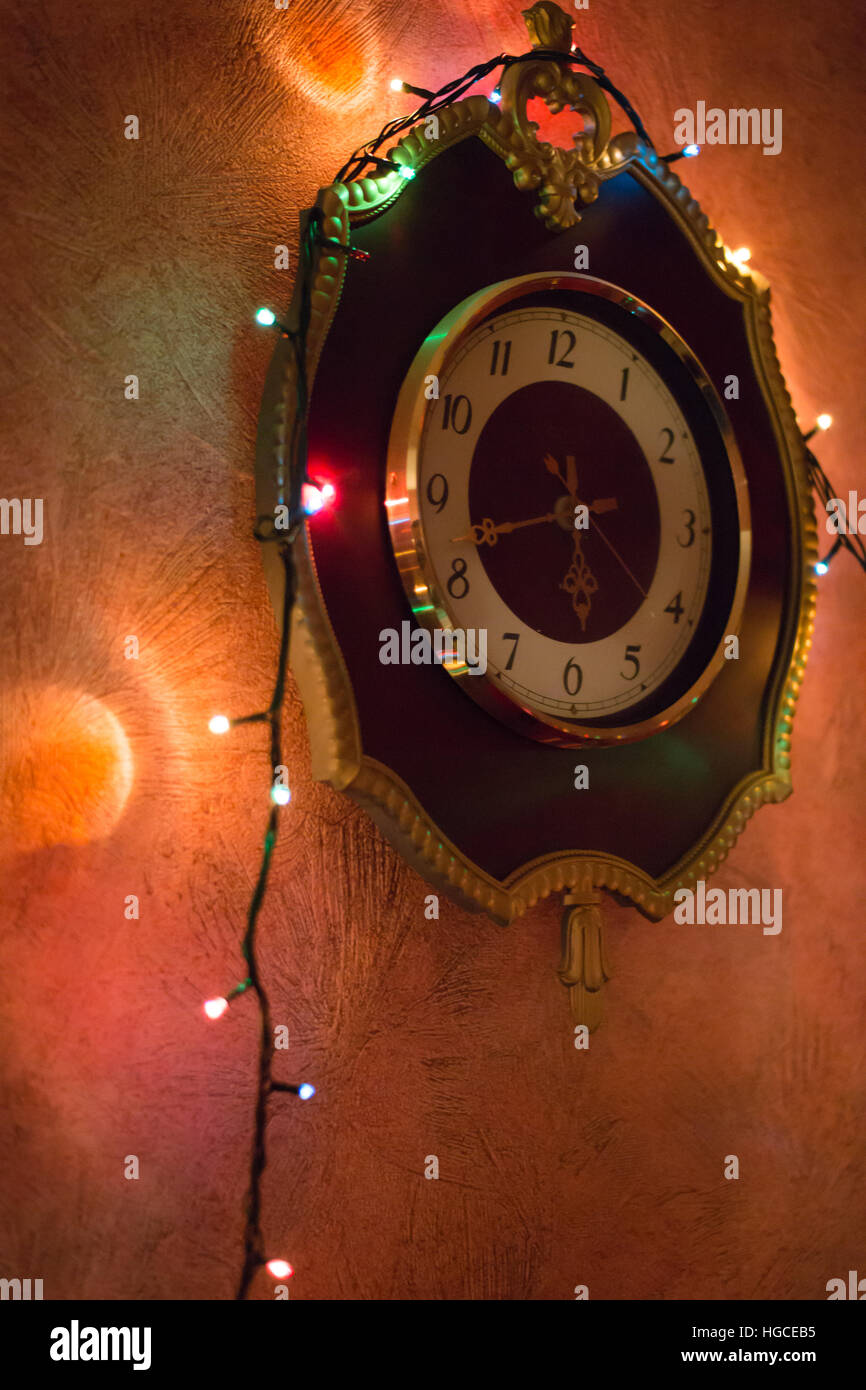 Christmas background with lights on the old clock Stock Photo - Alamy