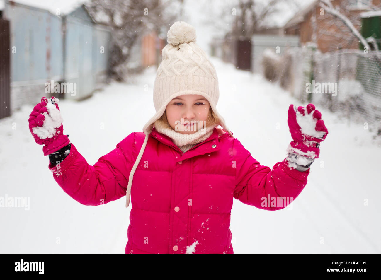 Adorable child girl playing outdoor with snow Stock Photo