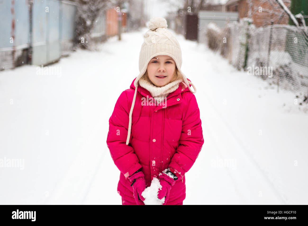 Adorable child girl playing outdoor with snow Stock Photo
