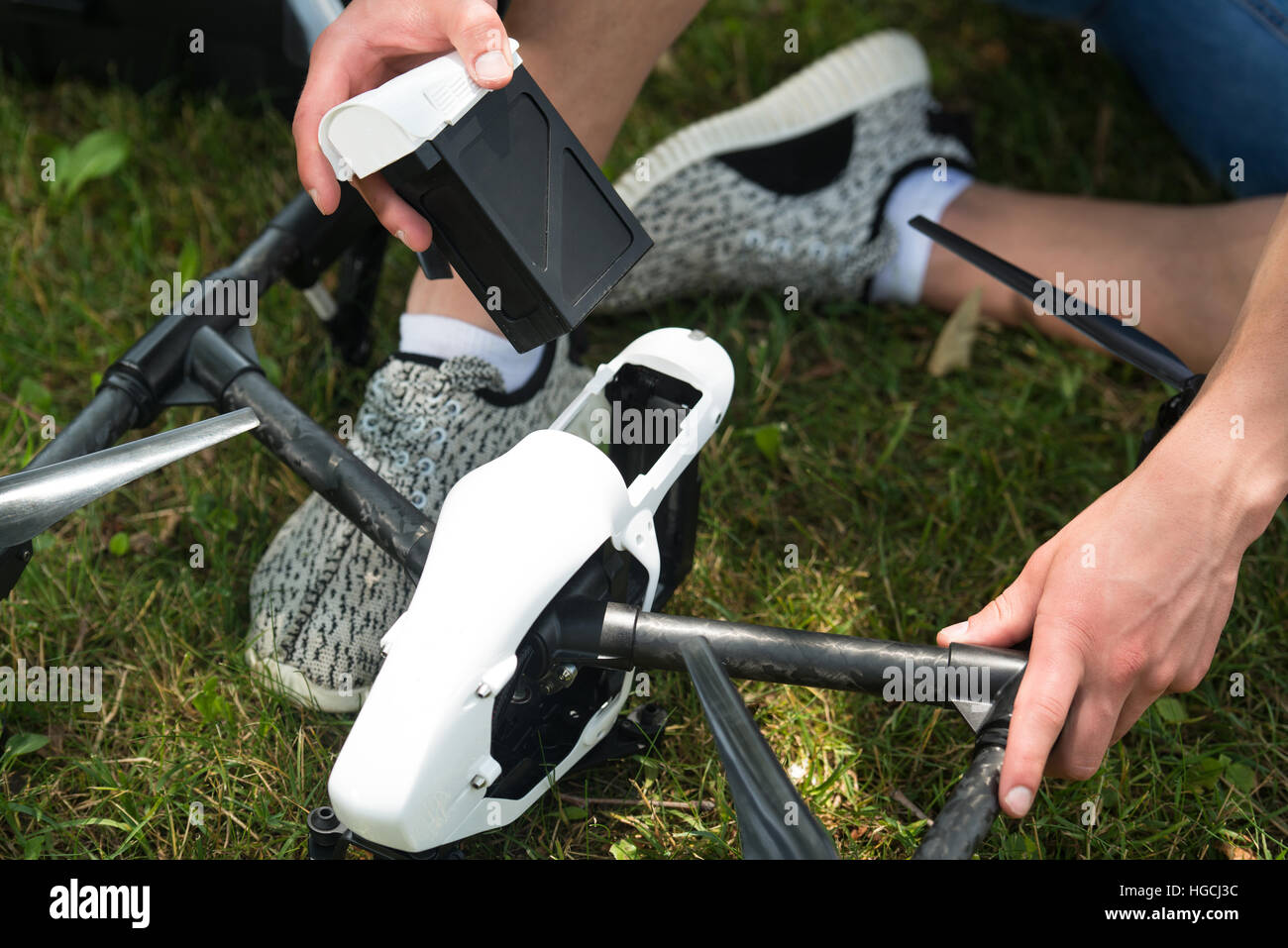 Closeup of Young Engineer Man Checking the Battery of Uav Drone With